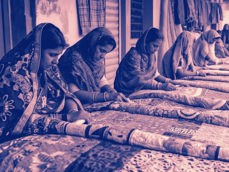 Artisans working together on a quilt